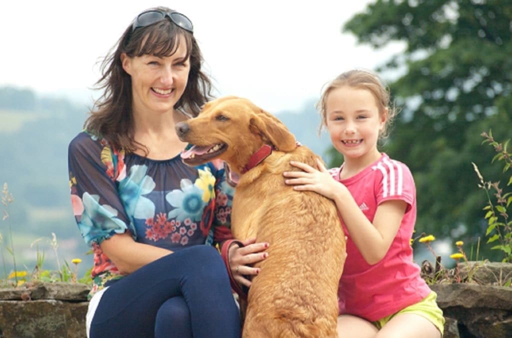 A family enjoying time with a golden dog